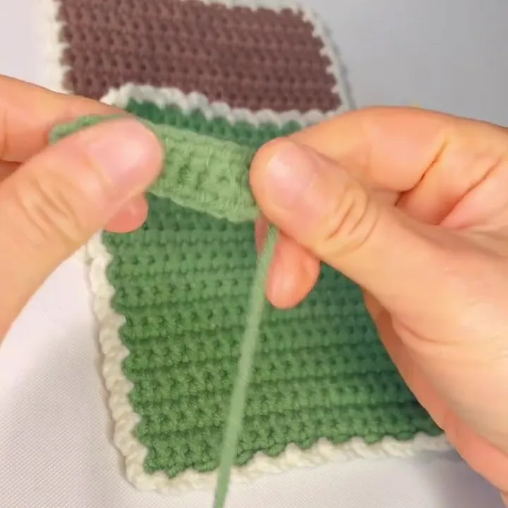 Turn back, then find the first stitch and make a slip stitch to finish the hanging loop. Turn back, then find the first stitch and make a slip stitch to finish the hanging loop.