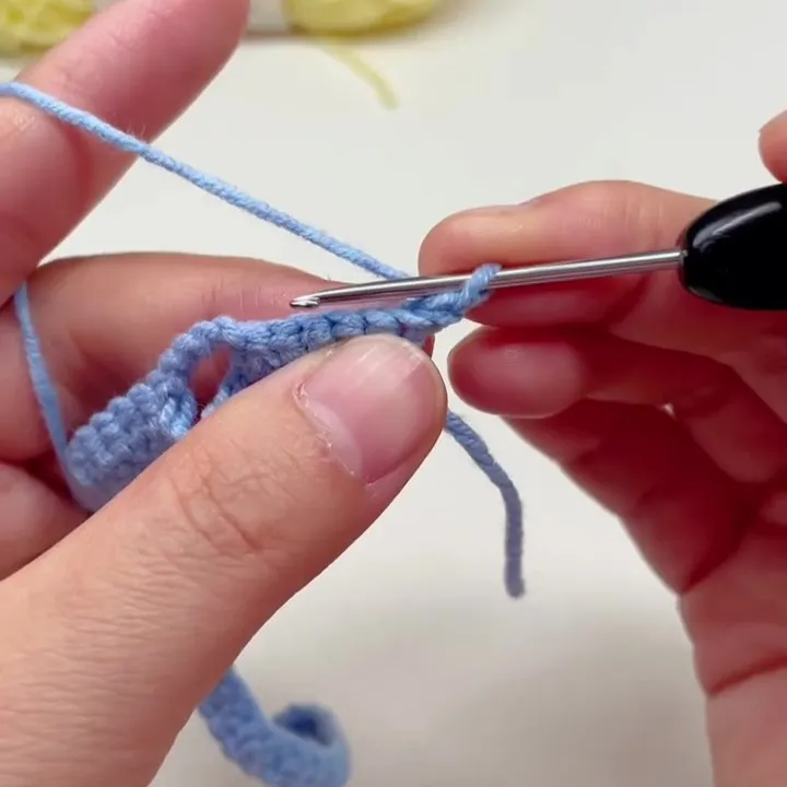 Turn the Work After Chain 1 Crochet work being turned after making one chain stitch at the end of the row