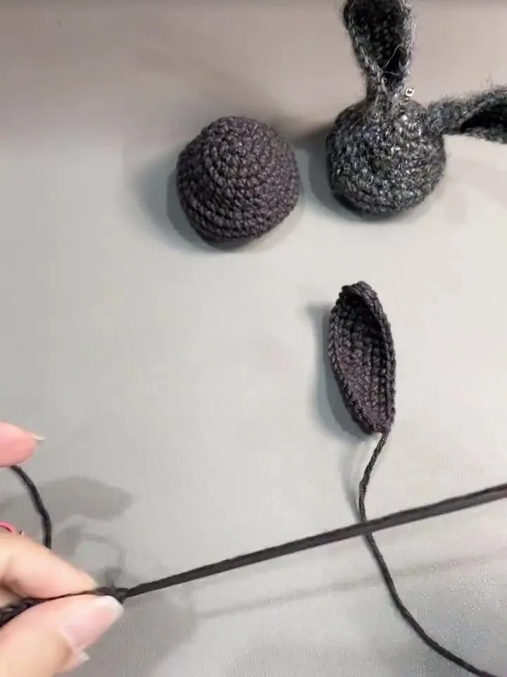 crochet bunny head and one ear piece before assembly