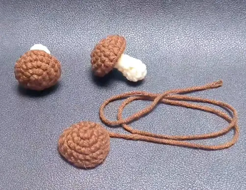 crochet mushroom cap pieces and finished tiny mushrooms shown before assembly
