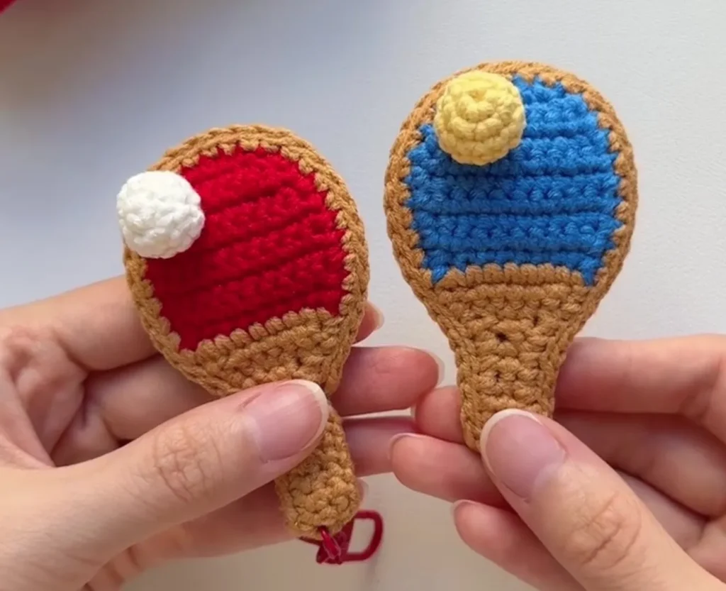 sewing two crochet ping pong paddle pieces together