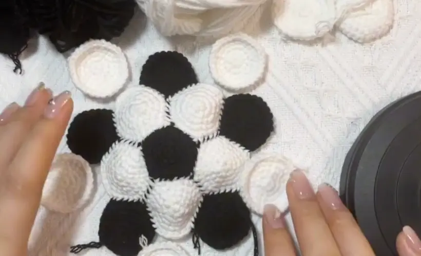Mini Crochet Soccer Ball Pattern: The Layout Is the Real Trick 4 Crochet soccer ball pieces being arranged with black pentagons between white hexagons