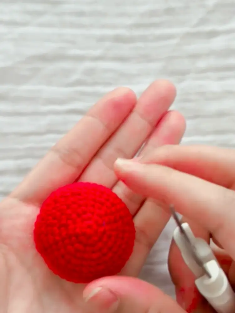 Tiny Crochet Tomato Pattern: A Quick 5-Minute-Style Project for Beginners 1 Finished red crochet tomato body held in hand before the green leaf top is added