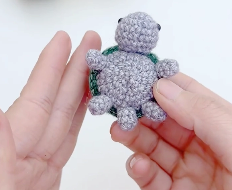Mini Crochet Turtle Pattern for Beginners: Tiny Amigurumi Turtle 5 Finished mini crochet turtle with green shell, gray body, head, legs, and tail