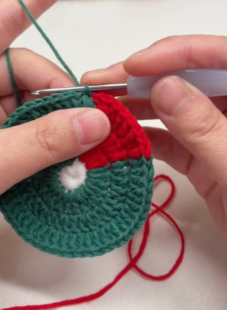 Santa Hat Crochet Coaster: A Festive Beginner Christmas Pattern 4 Crochet Santa hat coaster in progress with the red hat body finished before the white brim is added